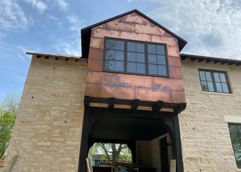 Copper metal panel facade on a stone building for Metal Roof Coating in Del Rio