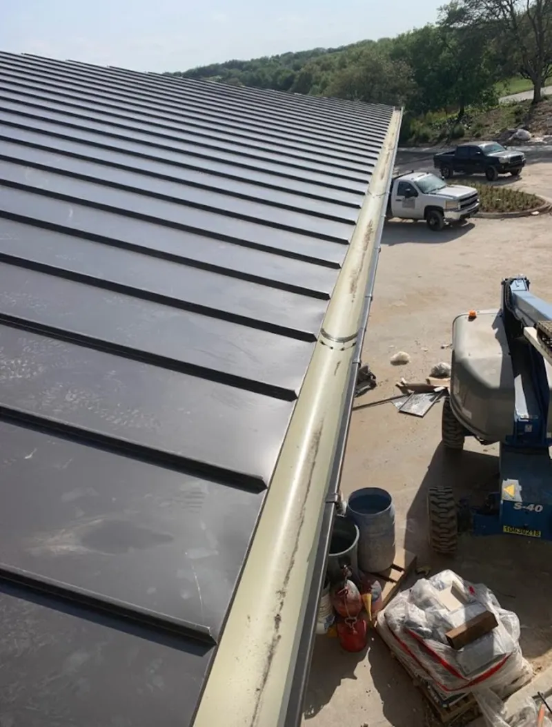 Standing seam panel and gutter detail on a metal roofing jobsite in Del Rio